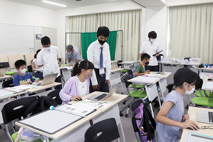 中部大学第一高等学校の教員や高校生に教わりながらプログラミングに挑戦