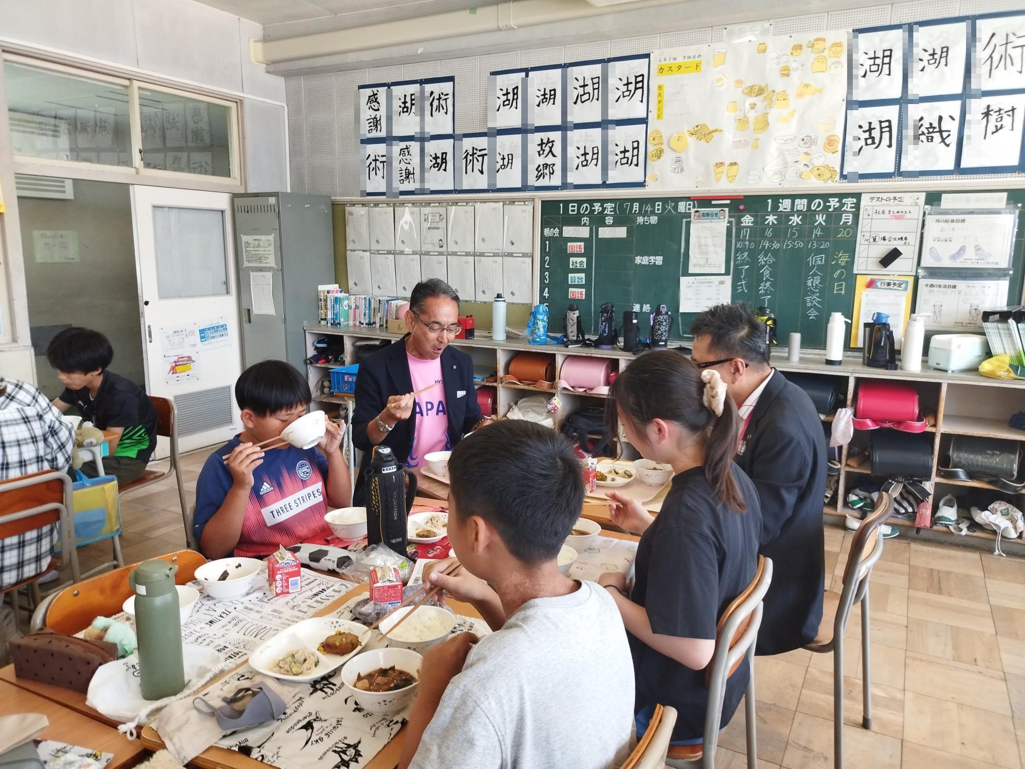 一緒に給食を食べる教育長と生徒