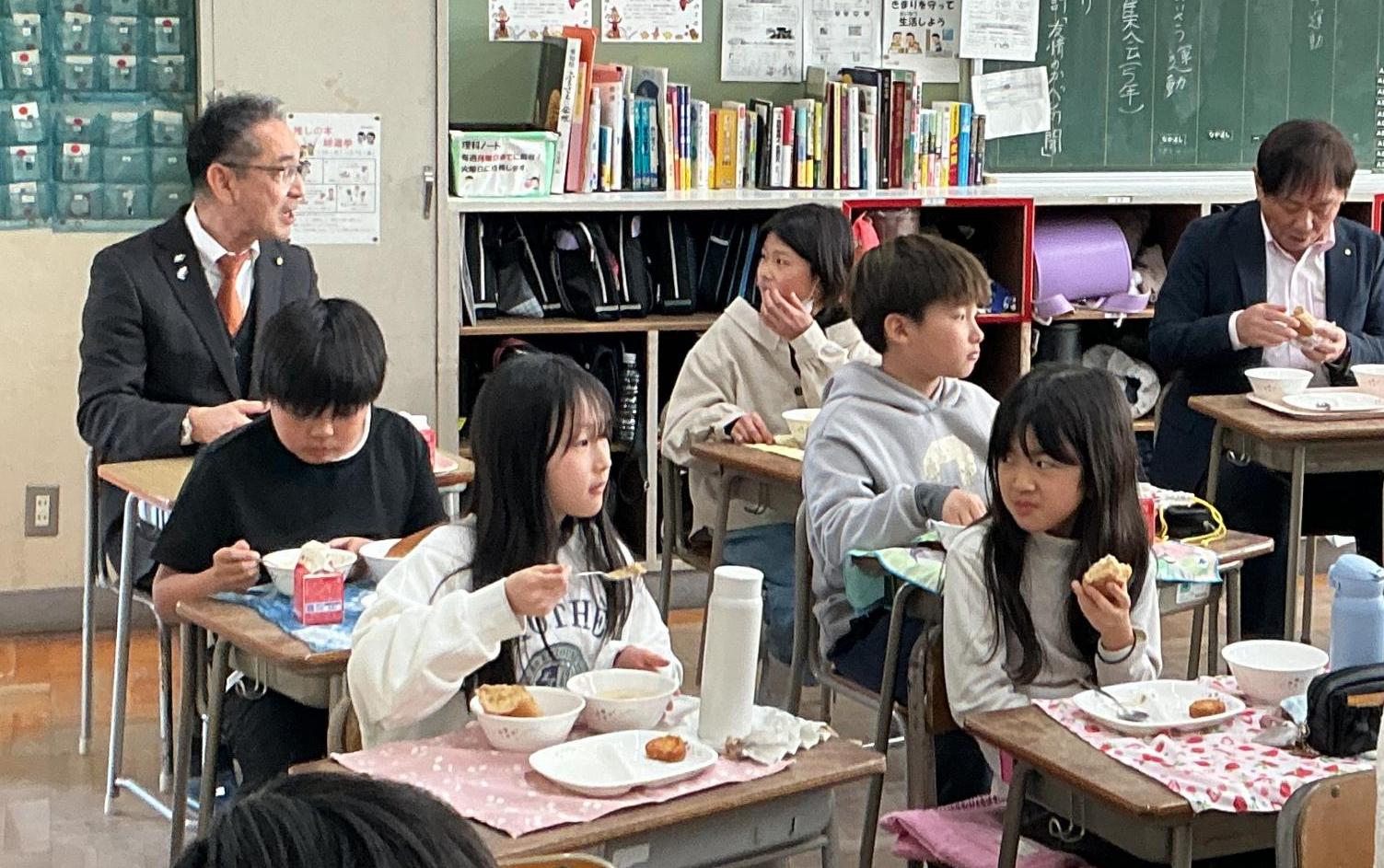 談笑しながら給食を楽しむ教育長と児童
