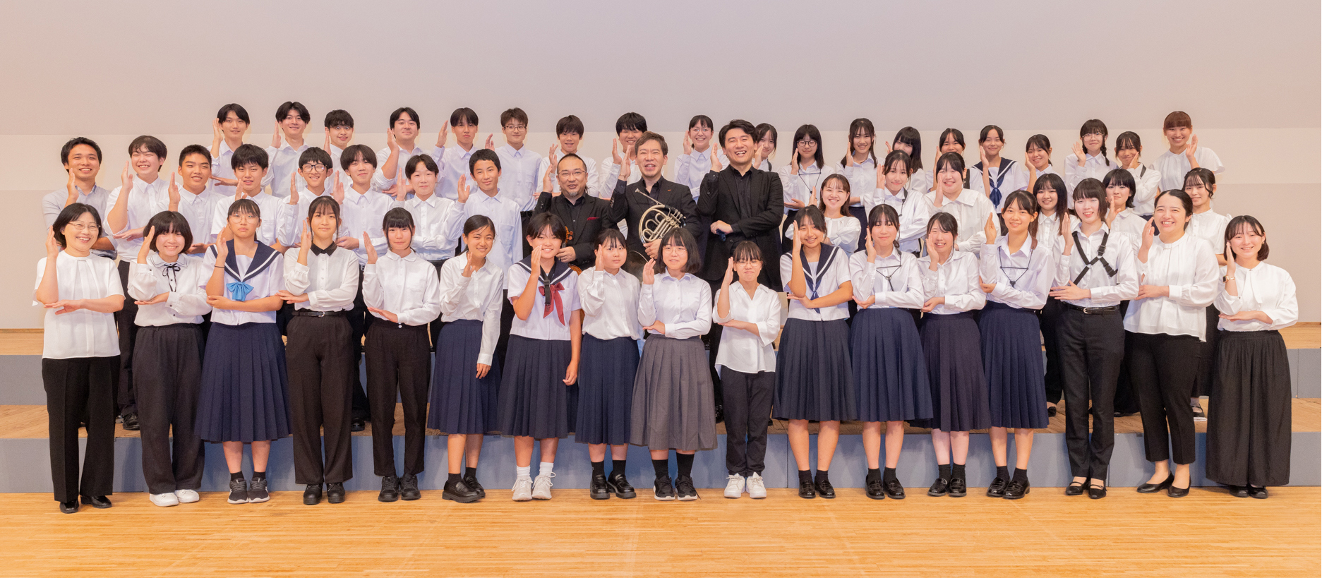こども達からのリクエストに応じて同じポーズで集合写真に応じるホルン奏者の福川さん、ヴァイオリン奏者の長原さん、ピアノ奏者の秋元さんとこどもたちの写真