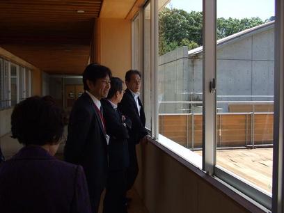 教育長、鈴木委員、成田委員が梨の木小学校を訪問し窓にむかって懇談している様子の写真